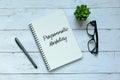 Business concept. Top view of plant,glasses,pen and notebook written with Programmatic Marketing. Royalty Free Stock Photo