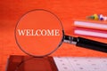 Business Concept. Welcome text written through a magnifying glass on an orange background Royalty Free Stock Photo