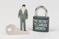 A figurine of a businessman, a key and a lock with the inscription - The secret to career growth Royalty Free Stock Photo