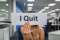 Woman hold paper of I quit in office