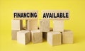 Business concept on wooden cubes. Text Financing is available.