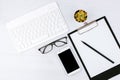 Business concept. Work from home. Office flatlay with white keyboard, reading glasses, pet and notebook. Top view