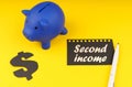On a yellow background there is a piggy bank, a dollar symbol and paper with the inscription - Second income Royalty Free Stock Photo