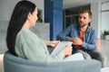 Business concept. Young dark-haired woman sitting in front of mature cheerful office manager on job interview, having Royalty Free Stock Photo