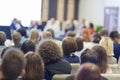 Business Concepts. People At the Conference Listening to Hosts Speakers Sitting In Front On Stage Before The Audience Royalty Free Stock Photo