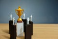 Business conceptual photo Ã¢â¬â group miniature of businessman have a group discussion above wooden puzzle block to reach golden