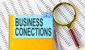 BUSINESS CONECTIONS text on sticker on the notebook with magnifier and chart. Business concept Royalty Free Stock Photo