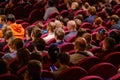 Business conference attendees sit and listen