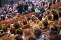 Business conference attendees sit and listen