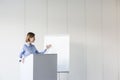 Businesswoman giving presentation at podium in office Royalty Free Stock Photo