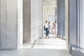 Business professionals planning while standing in corridor at office Royalty Free Stock Photo