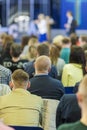 Business Conferences Concepts and Ideas. Two Hosts Speaking In front of the Large Group of People