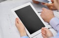 Architects with tablet pc and blueprint at office Royalty Free Stock Photo