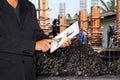 Business Construction Site, Businessman using tablet and Blurred background Construction workers