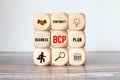BUSINESS CONTINUITY PLAN, text on wooden block on a gray BACKGROUND. Royalty Free Stock Photo