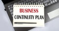 Business continuity Plan - Top view notebook writing on the laptop Royalty Free Stock Photo