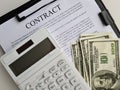 Business contract one hundred dollar bills and calculator Royalty Free Stock Photo
