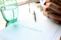 Business contract with pen is ready to sign. A glass of water Royalty Free Stock Photo