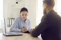 Happy female client during meeting in office signs paper document certifying rent or loan. Royalty Free Stock Photo