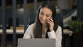 Business corporate work emotional smiling businesswoman working with computer talking mobile phone woman office worker Royalty Free Stock Photo