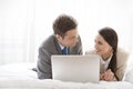 Business couple with laptop looking at each other in hotel room Royalty Free Stock Photo