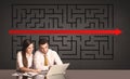 Business couple with a solved puzzle in background Royalty Free Stock Photo