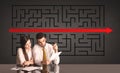 Business couple with a solved puzzle in background Royalty Free Stock Photo