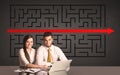 Business couple with a solved puzzle in background Royalty Free Stock Photo
