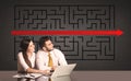 Business couple with a solved puzzle in background Royalty Free Stock Photo