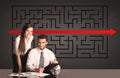 Business couple with a solved puzzle in background Royalty Free Stock Photo