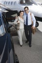 Business Couple Standing Together At Airfield Royalty Free Stock Photo