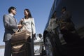 Business Couple Standing Together At Airfield