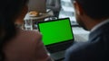 Business couple video chatting on laptop chroma key screen in cafe coworking.