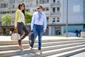 Business couple walking down the stairs and smiling Royalty Free Stock Photo