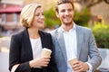 Business Couple Walking Through Park With Takeaway Coffee Royalty Free Stock Photo