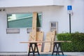 Business covering windows with plywood in anticipation of a hurricane storm