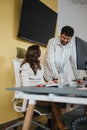 Business coworkers discussing reports and strategizing for profit growth Royalty Free Stock Photo