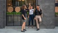 Business coworkers talking together on pathway outside business building