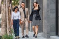 Business coworkers walking together on pathway outside business building