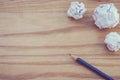 Top view of three pencil with white crumpled paper ball put on wooden floor. Royalty Free Stock Photo