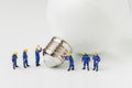 Business creative idea, sustainability power or energy generator concept, miniature people figurine engineer worker help building Royalty Free Stock Photo