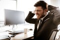 Business crisis concept. Emotional young businessman at work. Worried stressed manager sitting at the office table tears Royalty Free Stock Photo