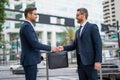 Business deal. Two business man hold business briefcase. Business contract transfer deal. Handover of a suitcase in Royalty Free Stock Photo