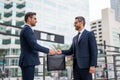 Business deal. Two business man hold business briefcase outdoor. Business transfer deal. Handover of a suitcase in hands Royalty Free Stock Photo