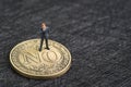 Business decision, investment risk, decline or say no concept, miniature businessman thinking and standing on gold coin face with Royalty Free Stock Photo