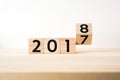 Surreal abstract geometric floating wooden cube with word 2017 and 2018 concept on wood floor and white background Royalty Free Stock Photo