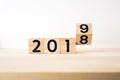 Surreal abstract geometric floating wooden cube with word 2019 and 2018 concept on wood floor and white background Royalty Free Stock Photo