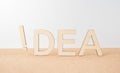 Wooden word ` idea ` with exclamation mark on wooden desktop and white background