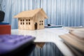 Business desk close up with house wood model. Royalty Free Stock Photo