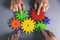 Business development, teamwork and partnership concept - people connecting gears Royalty Free Stock Photo